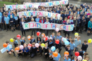 Broomhill Primary School gather in the playground to celebrate 25 years of the Convention on the Rights of the Child.